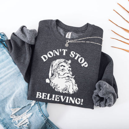 Sweatshirt S / Dark Heather Don't Stop Believing Santa Sweatshirt