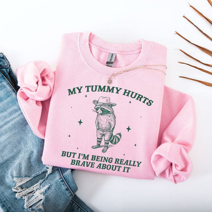 Sweatshirt S / Light Pink My Tummy Hurts But I'm Being Really Brave About It Raccoon Sweatshirt