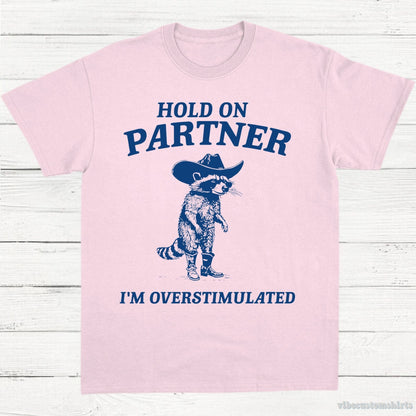 T-Shirt Light Pink / S Hold on Partner I'm Overstimulated Cowboy Raccoon Shirt