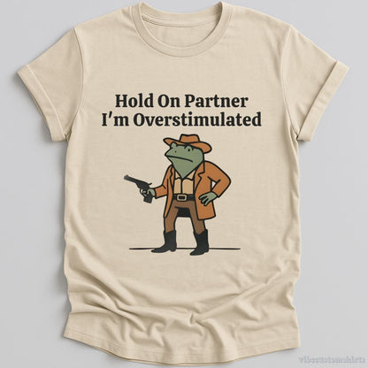 T-Shirt Natural / S Hold On Partner I’m Overstimulated Funny Cowboy Frog Shirt