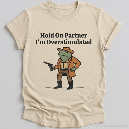 T-Shirt Natural / S Hold On Partner I’m Overstimulated Funny Cowboy Frog Shirt
